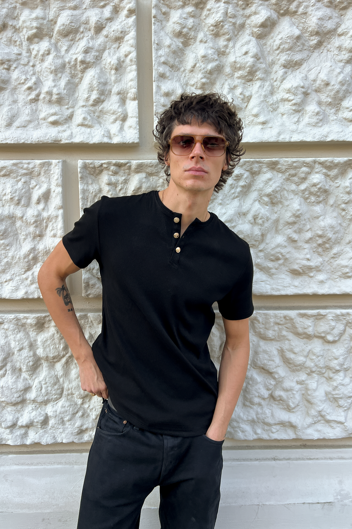 Model wearing the black Henley Shortsleeve by Rare Humans, front view