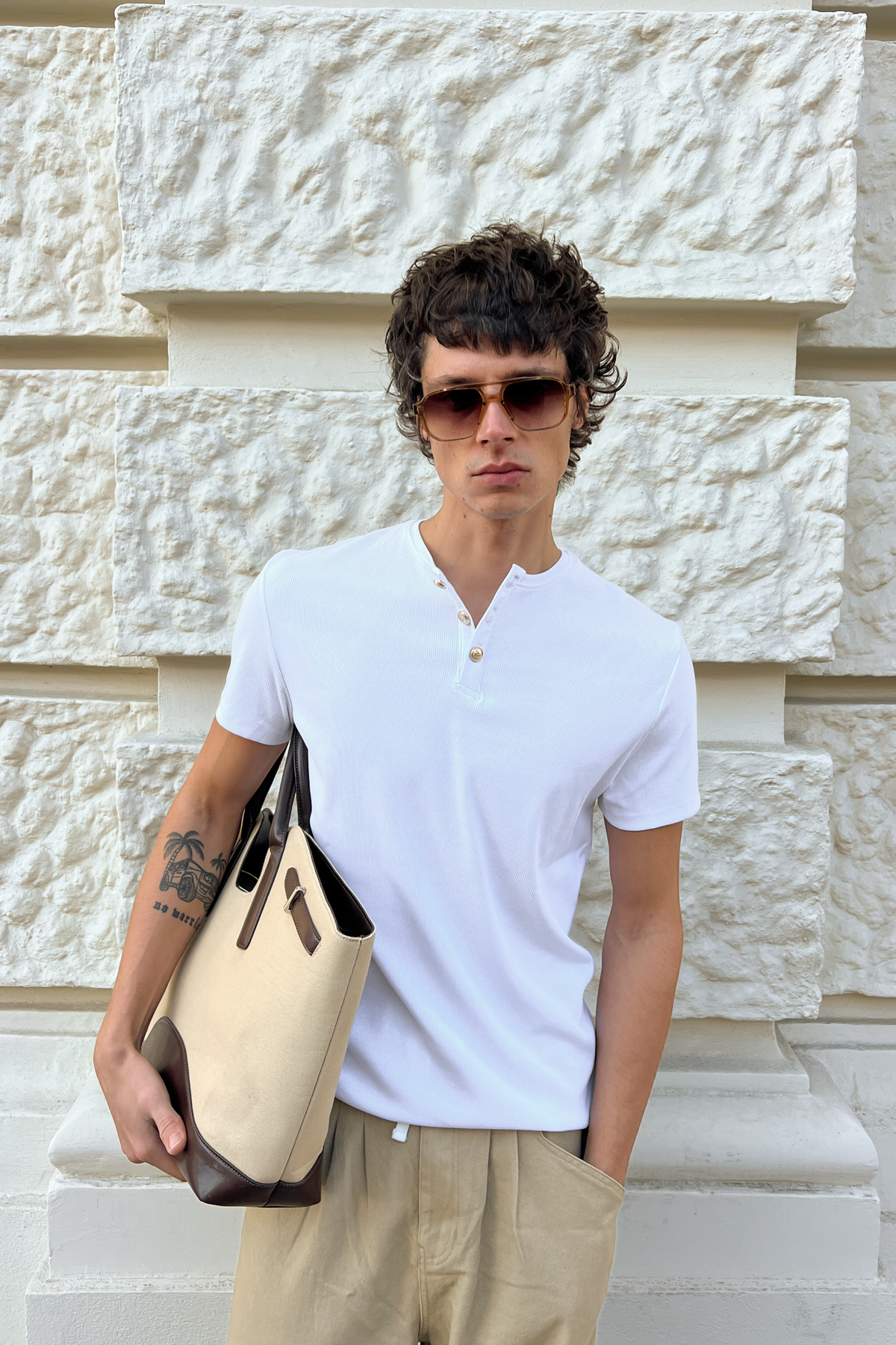 Model wearing the white Henley Shortsleeve by Rare Humans, front view