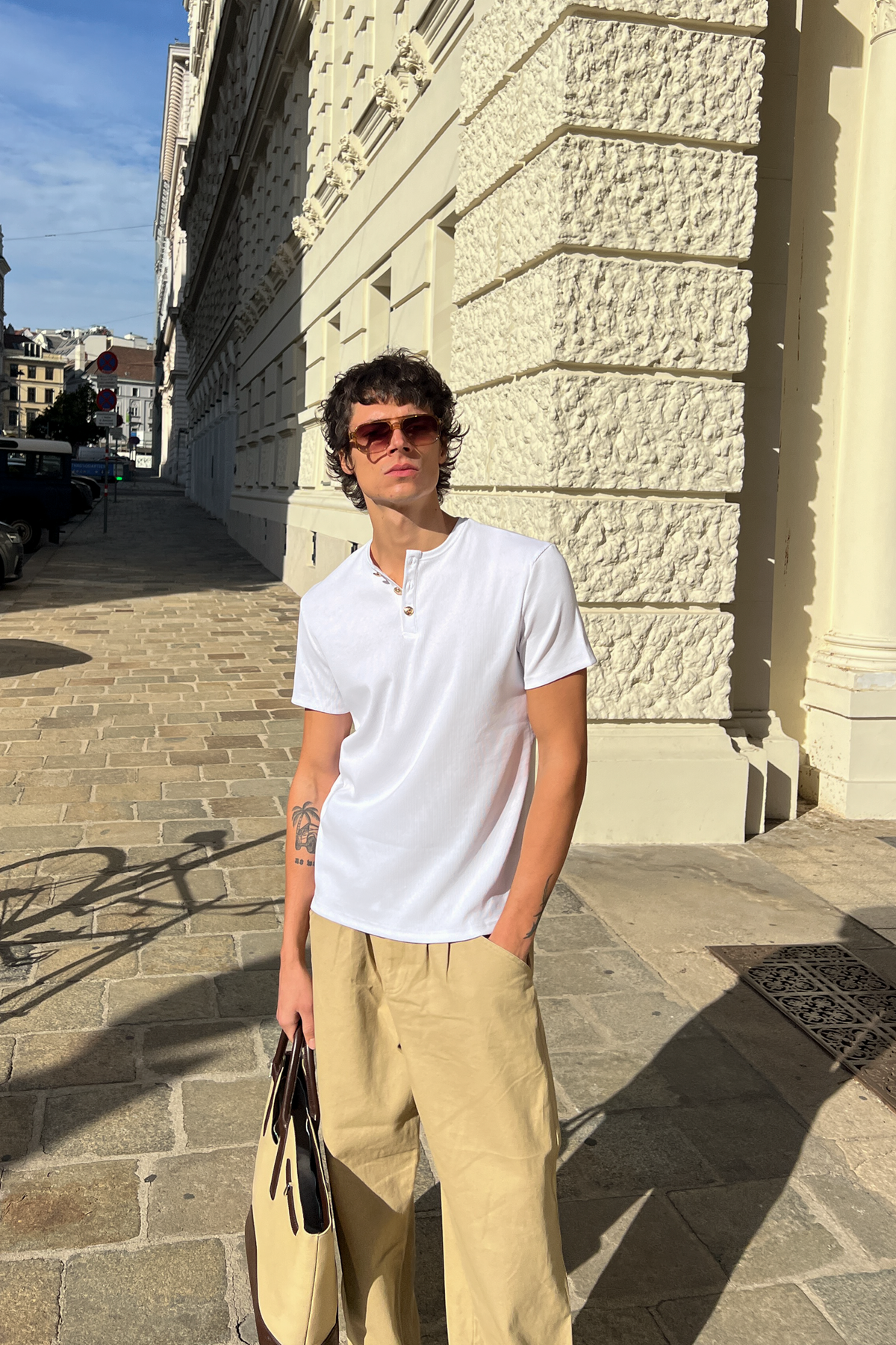 Model wearing the white Henley Shortsleeve by Rare Humans, front view