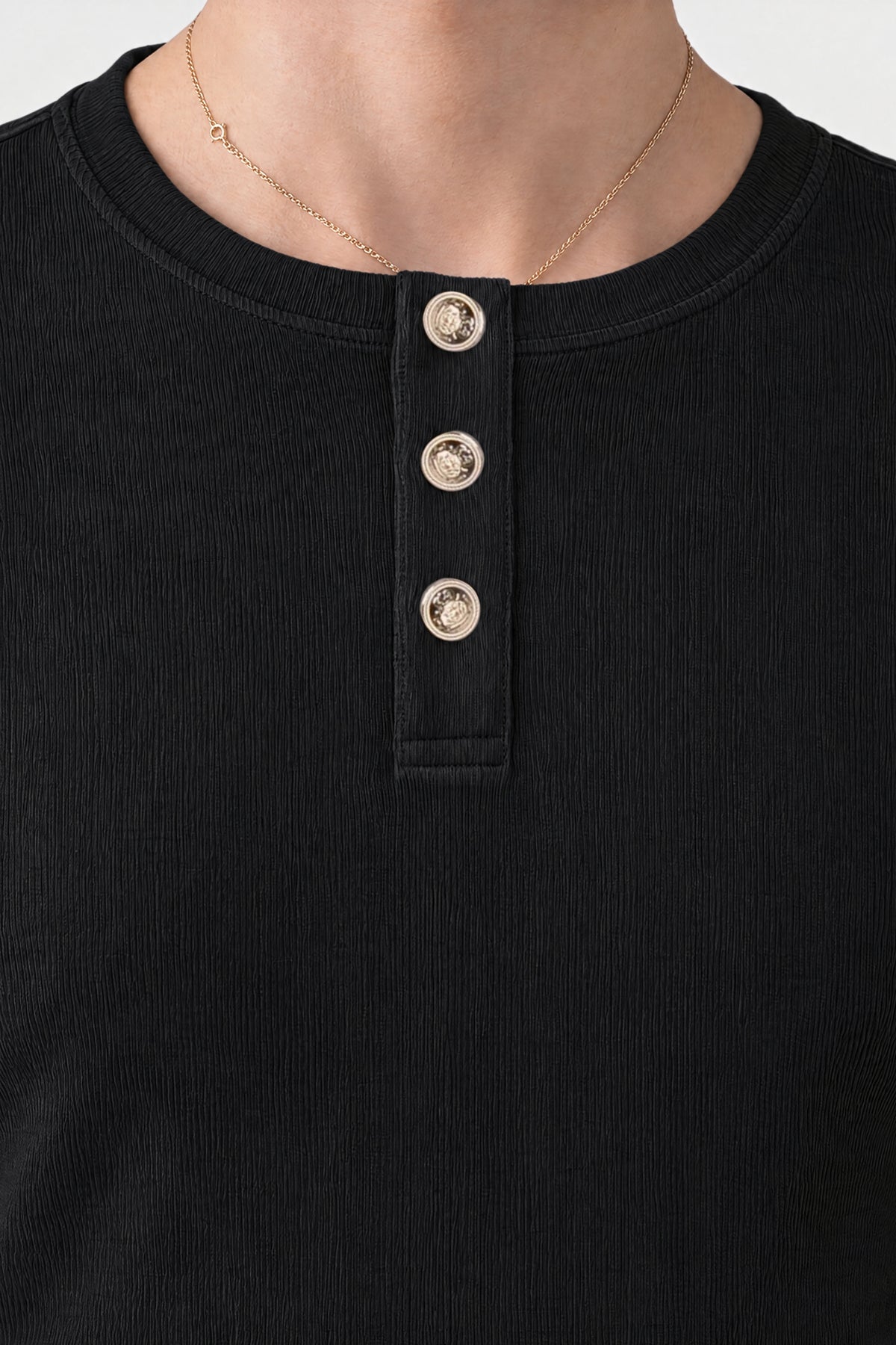 Close-up of the three-button placket with custom-made buttons on the black Henley Shortsleeve