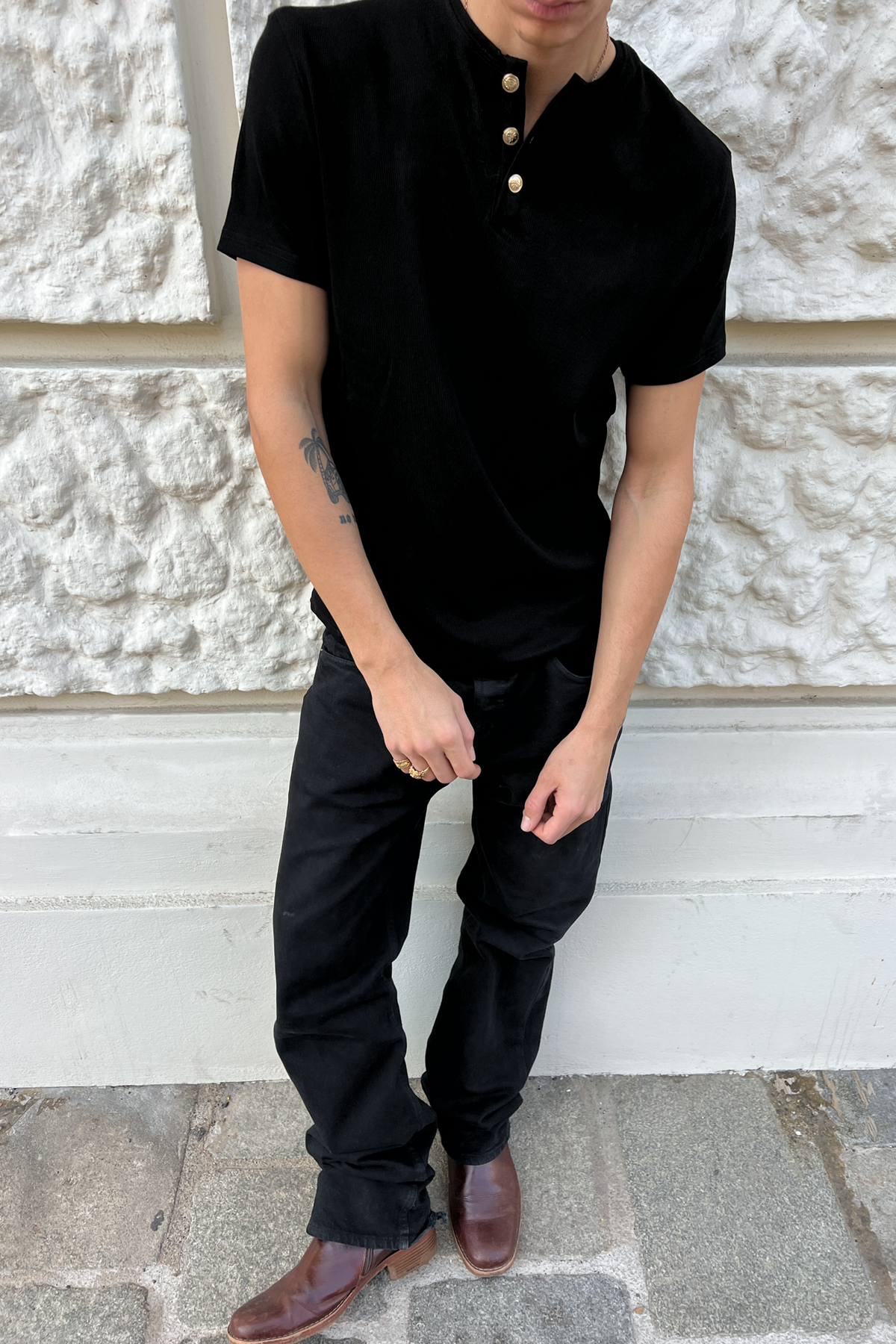 Model in the black Henley Shortsleeve with black trousers, full-length front view